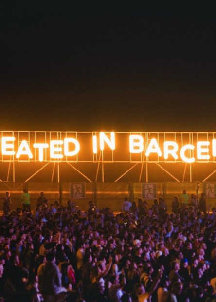 Made In Barcelona light up sign with fans in front